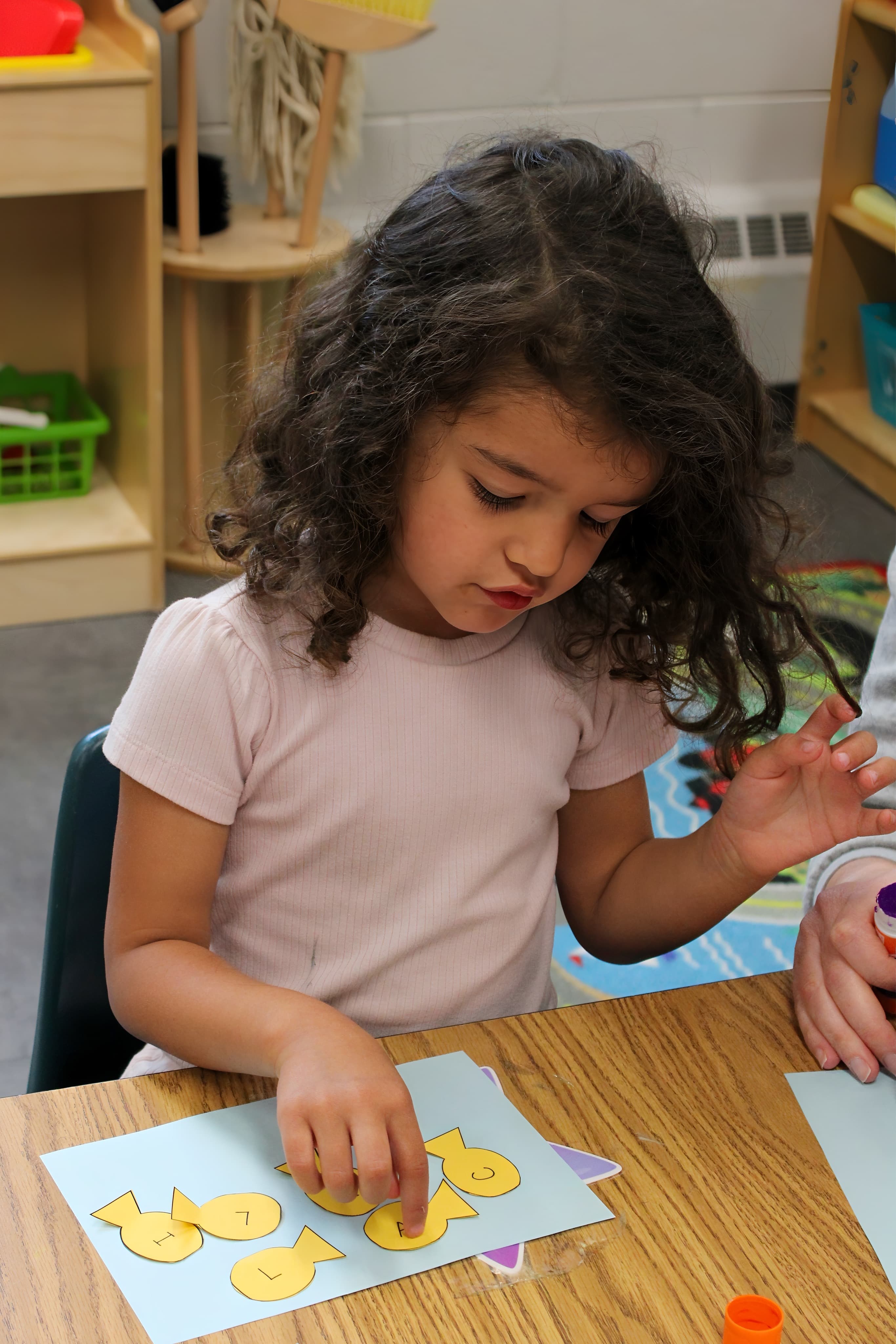 A child working on a hands-on activity at Rainbow Years Learning Ministry